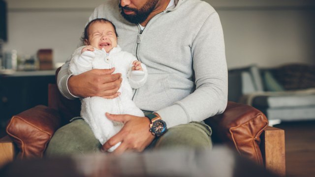 dad holding crying baby
