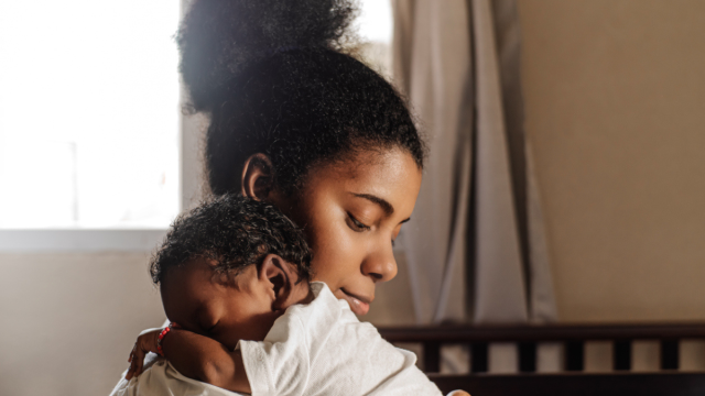 a mom with a sleeping baby