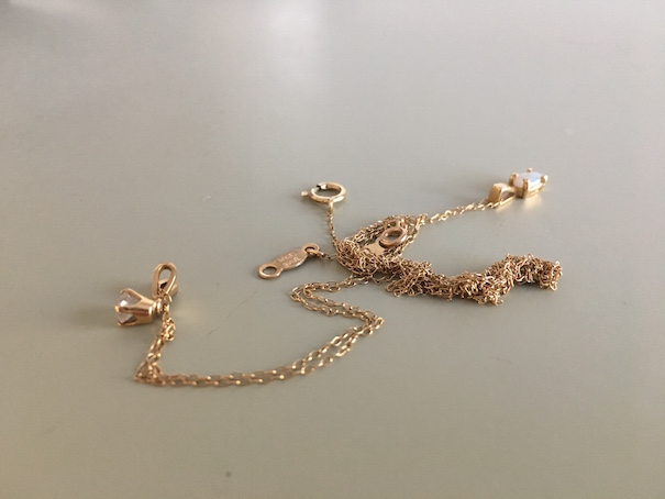 A tangled necklace chain that needs to be untangled