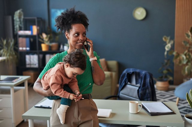 a picture of a mom bringing a baby on a job interview.