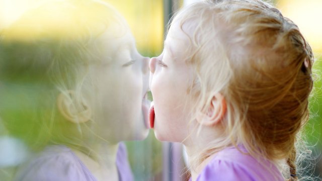 girl licking window