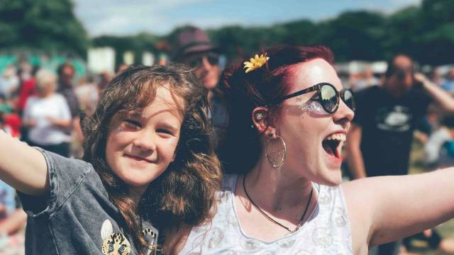 a mom and daughter at an outdoor summer concert