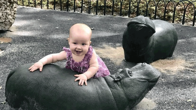 baby playing in the shade at Hippo Playground upper west side