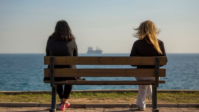 two women staring at the ocean