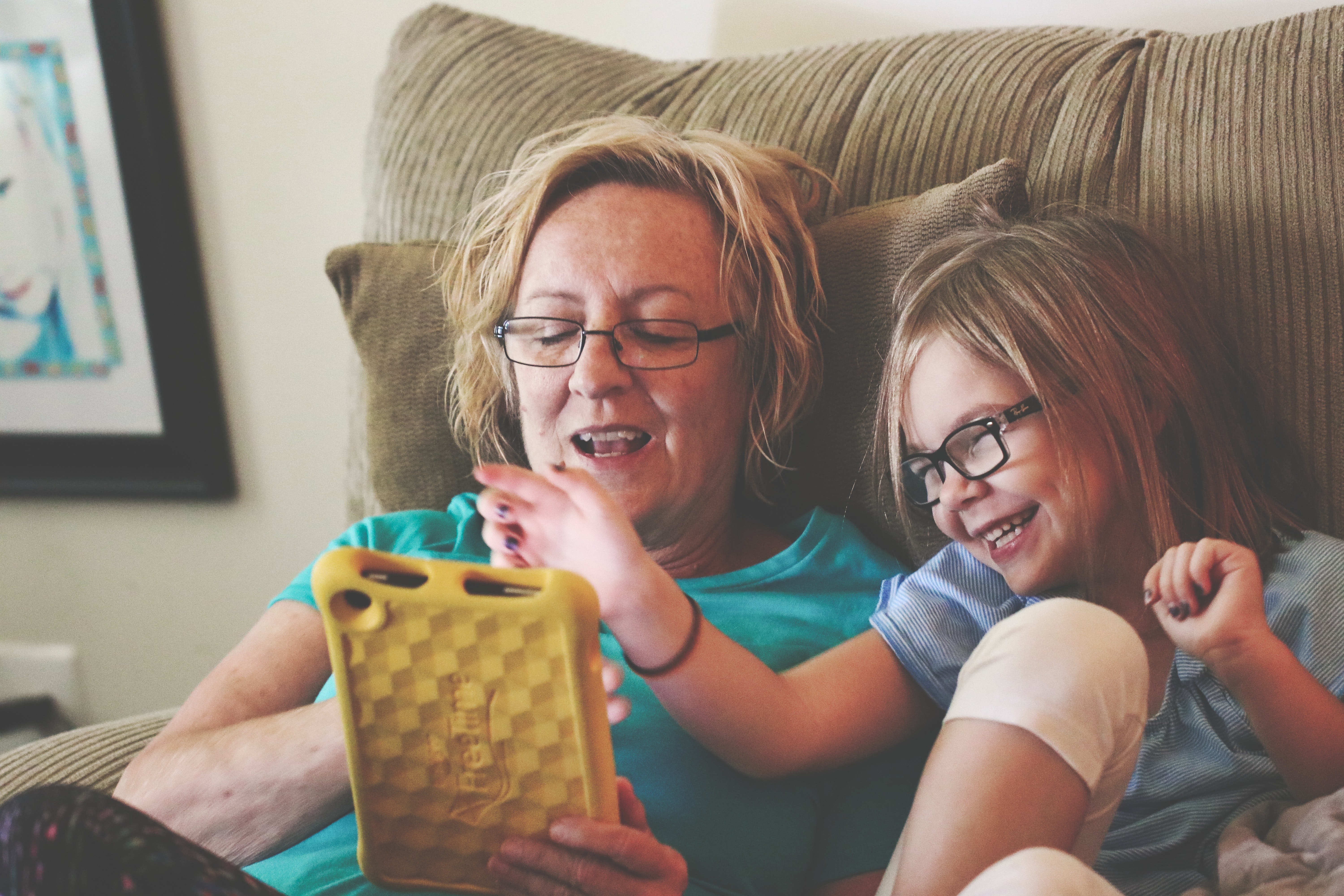 child and mom using tablet