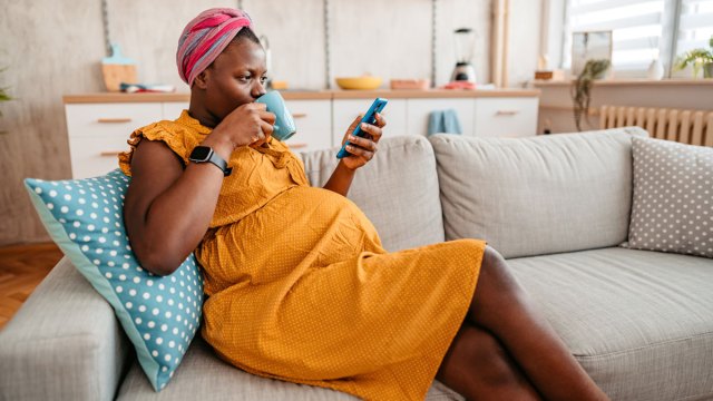 pregnant woman checking out facebook groups for moms
