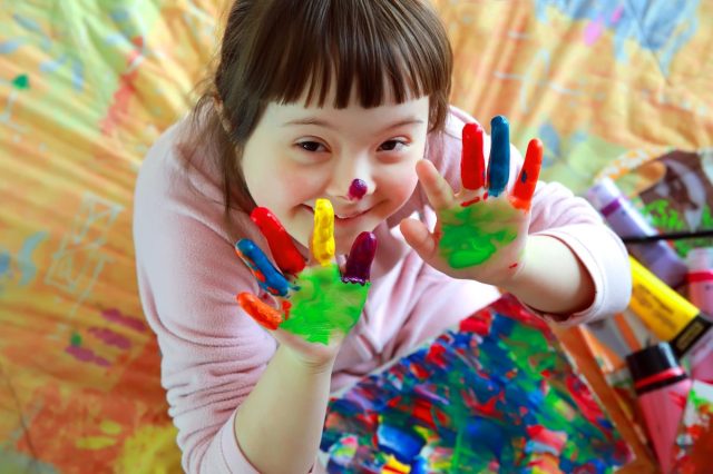 little girl enjoying art via an Outschool class.