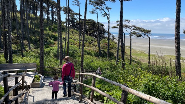 A family walks down to the beach at Seabrook, Wa