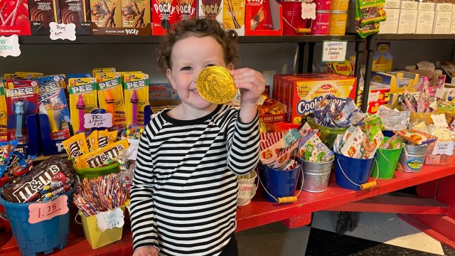 A kid shows off candy from the Sweet Life in Seabrook Wa