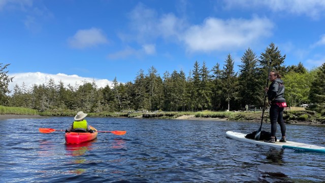 Two people kayak along the Copalis River near Seabrook Wa