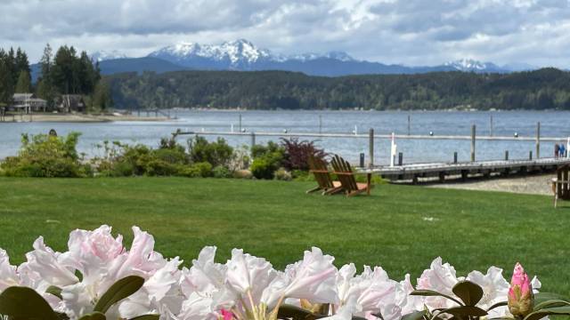 mountains loom over the hood canal on an overcast day in washinton