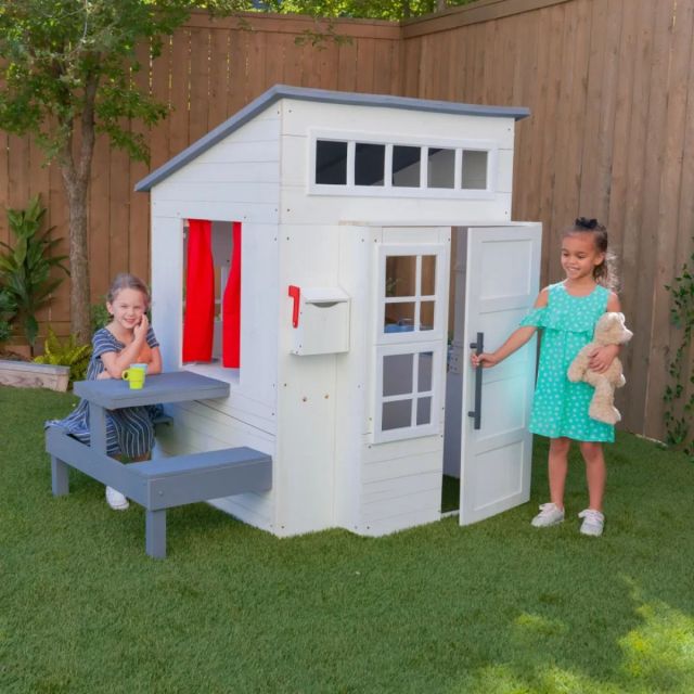 two little girls playing in outdoor modern playhouse