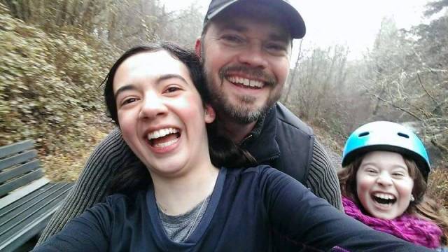 a father and two children biking on one of the best beginner bike paths in Portland