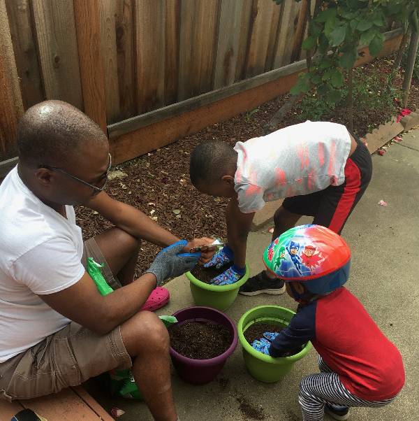 A father gardens with his children