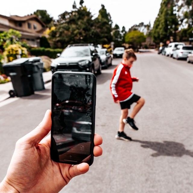 mom using iPhone, which is good YouTube equipment for beginners.