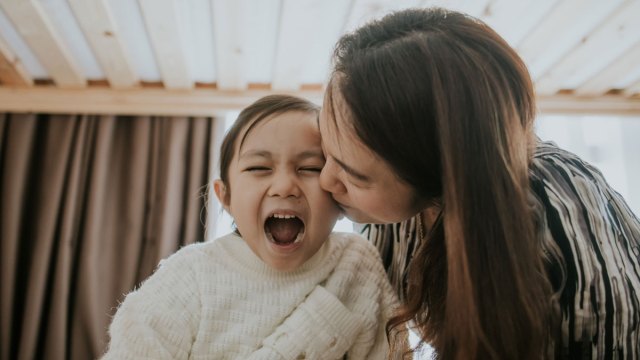 introvert mom kissing daughter