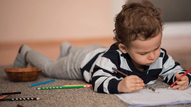 little boy enjoying coloring pages for toddlers