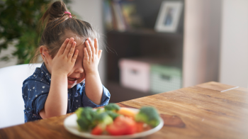 a little picky eater hiding from vegetables