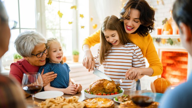 Thanksgiving with family laughing at Thanksgiving jokes