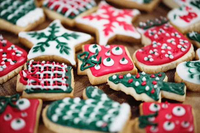 A pile of red, green, and white star and present shaped Christmas cookies