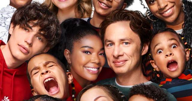 A smiling family crams together for a picture