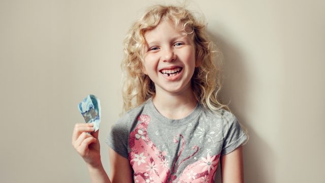 little girl after a visit from the tooth fairy