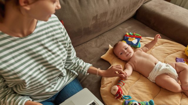 mother holding baby's hand