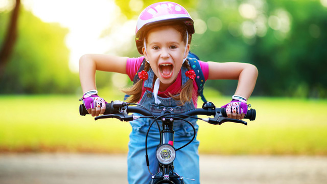 girl on a bike going through an obstacle course for kids