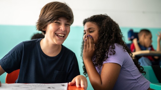 a boy and a girl telling riddles for kids at school