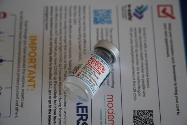 moderna vaccine authorization, moderna vial lying on paper
