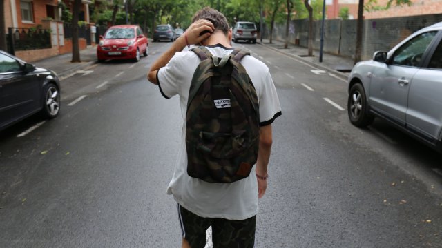 teen boy not listening walking down the street