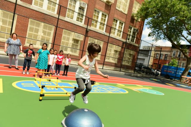 girl jumping in a queens playground