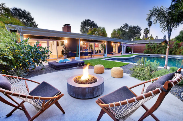 relaxing pool and backyard with 2 chairs