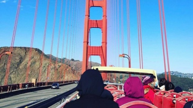 Riders on Big Bus cross the Golden Gate Bridge