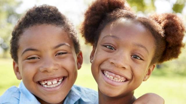 boy & girl siblings smiling and hugging - best sibling names
