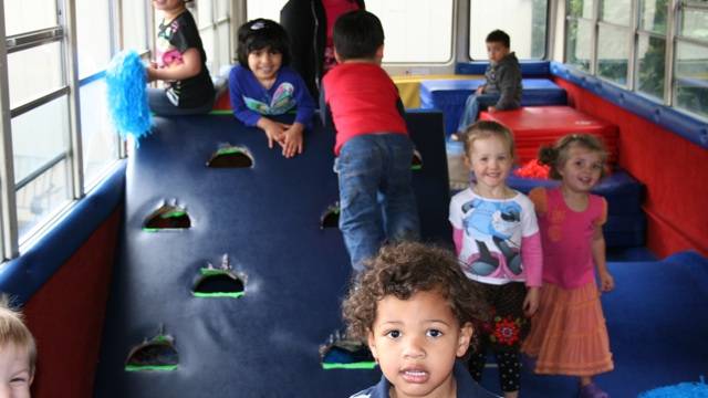 kids at an indoor birthday party seattle on dizzys tumblebus