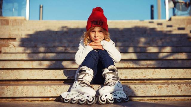 a kid sits on steps with skates on for an indoor birthday party seattle