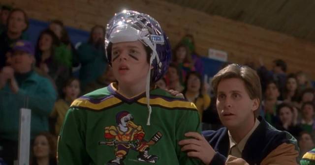 A hockey player and his coach look concerned