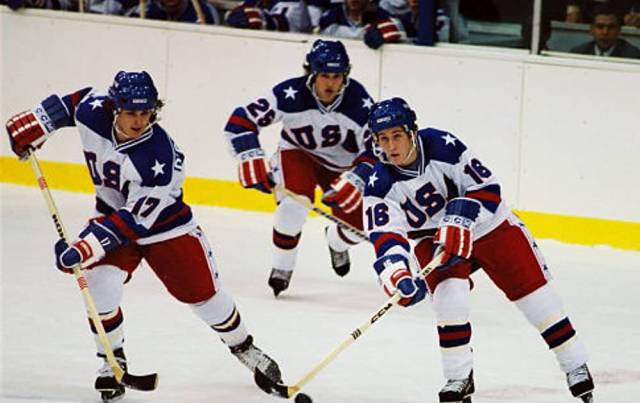Three hockey players chase the puck on the ice in "Miracle," which is one of the best family movies on Disney+