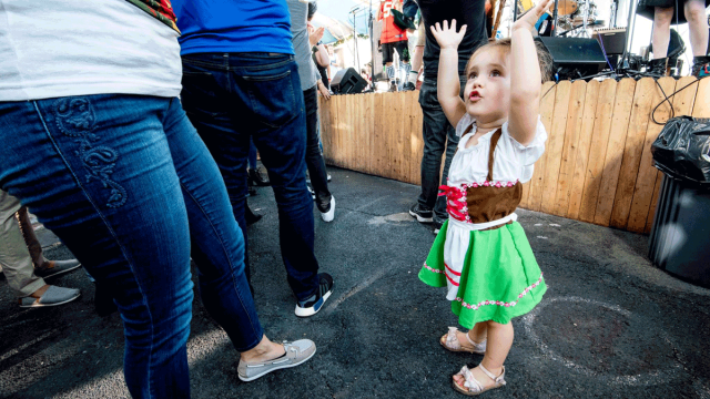 child in a beer garden with family