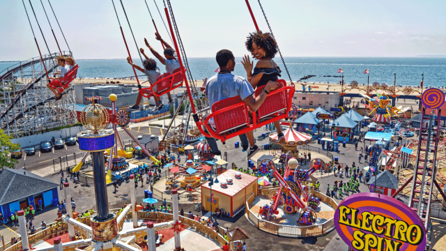 family enjoying coney island in the summer