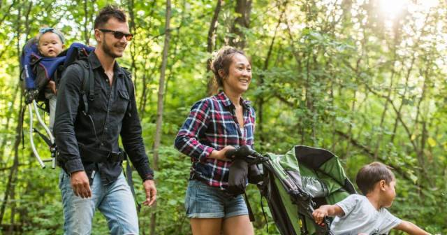 family hiking with baby and child in stroller - camping with baby