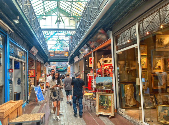 family walking through saint ouen flea market in paris, france