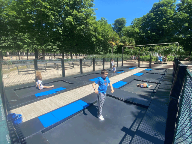 Children at trampolines in Tuileries Garden in Paris, France
