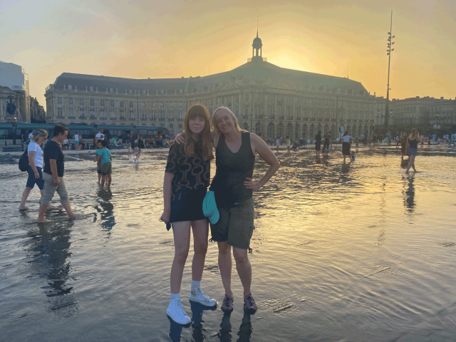 two women standing in Bordeaux's Miroir d'Eau