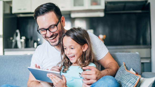a little girl and her dad watching YouTube channels for kids