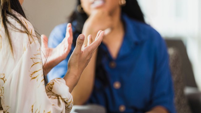 woman gesturing to her postpartum therapist