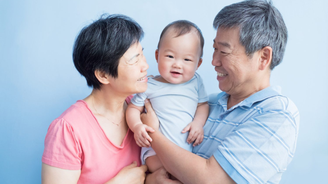 happy grandparents watching their grandbaby