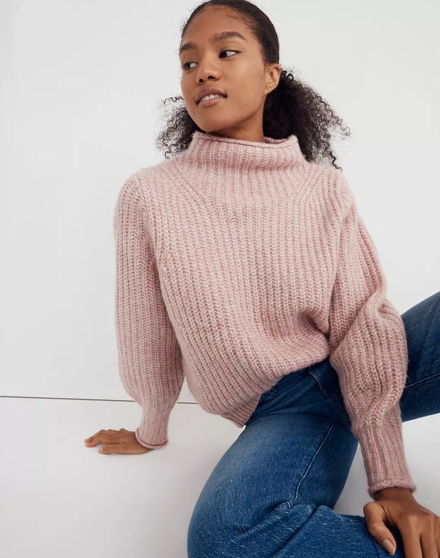 Woman in pink mockneck sweater