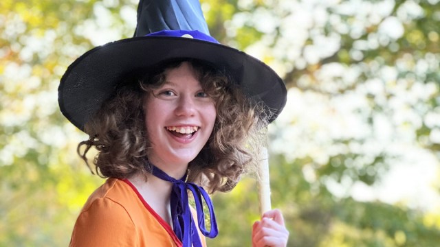 teen dressed in Halloween witch costume